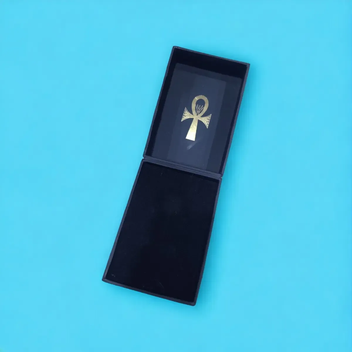 Open navy jewelry box with a black insert
