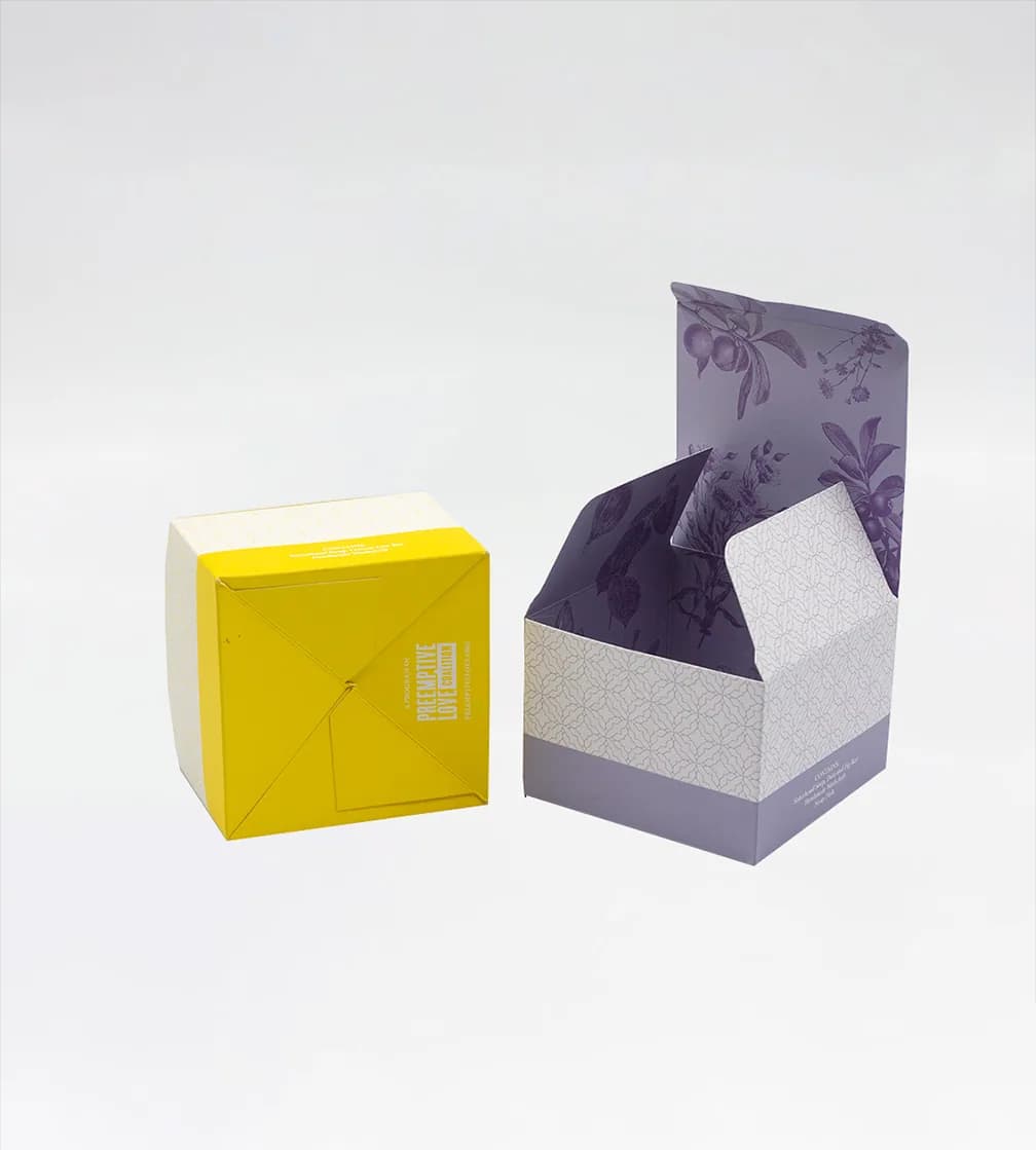 Yellow cube carton turned to show its auto-lock bottom