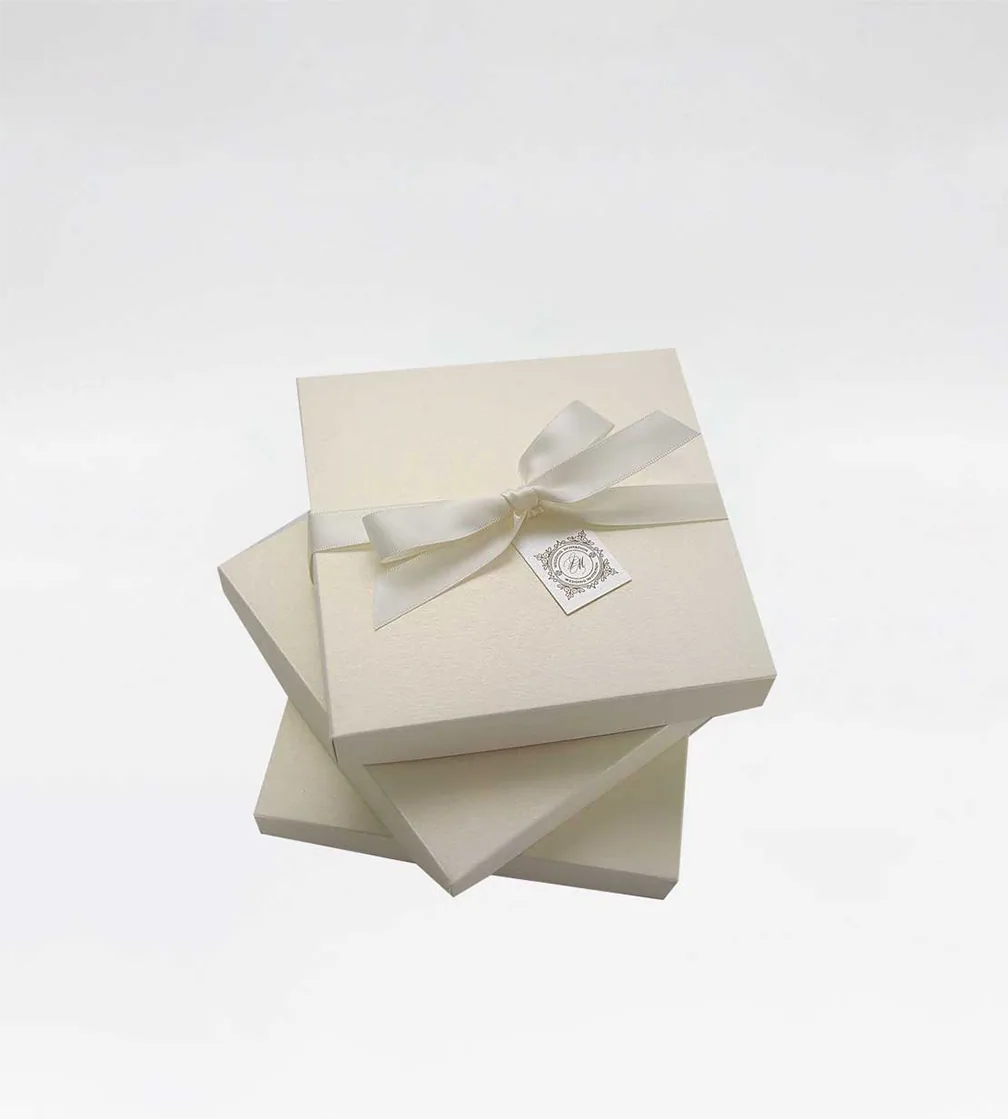 Stack of cream gift boxes with a bow