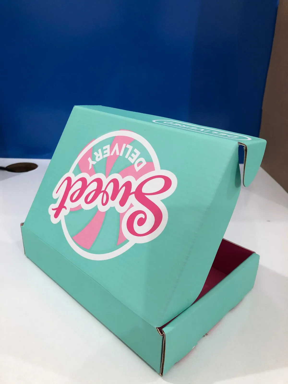 Mailer box open, lid raised, interior print