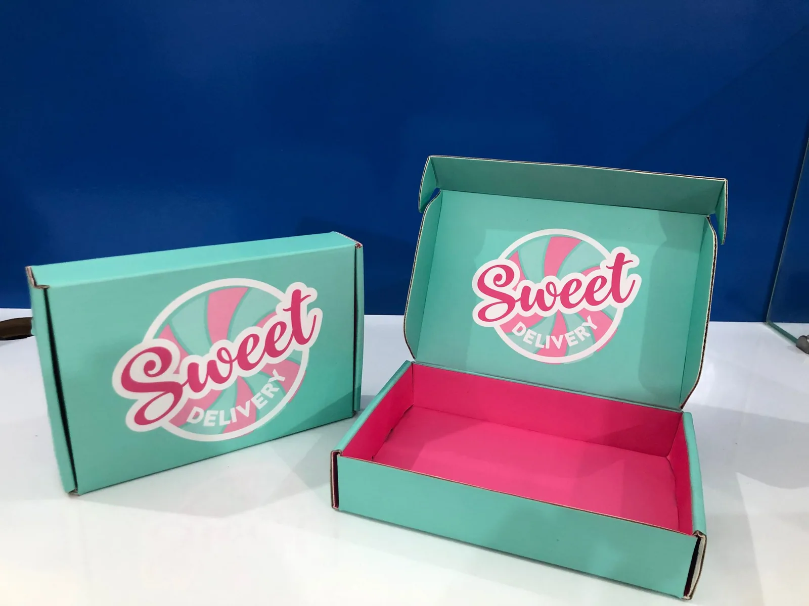 Two printed mailer boxes, one open to show the interior print