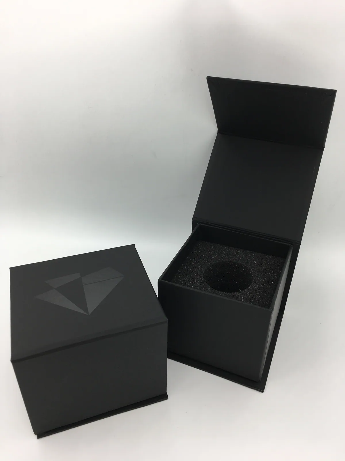 Black magnetic rigid box open to show a fitted insert
