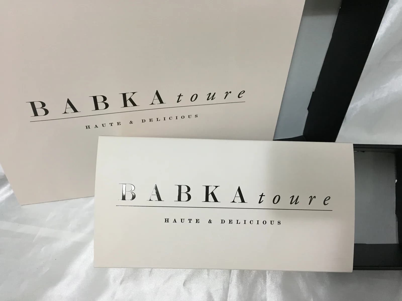 Cream sleeve and lid with silver foil lettering