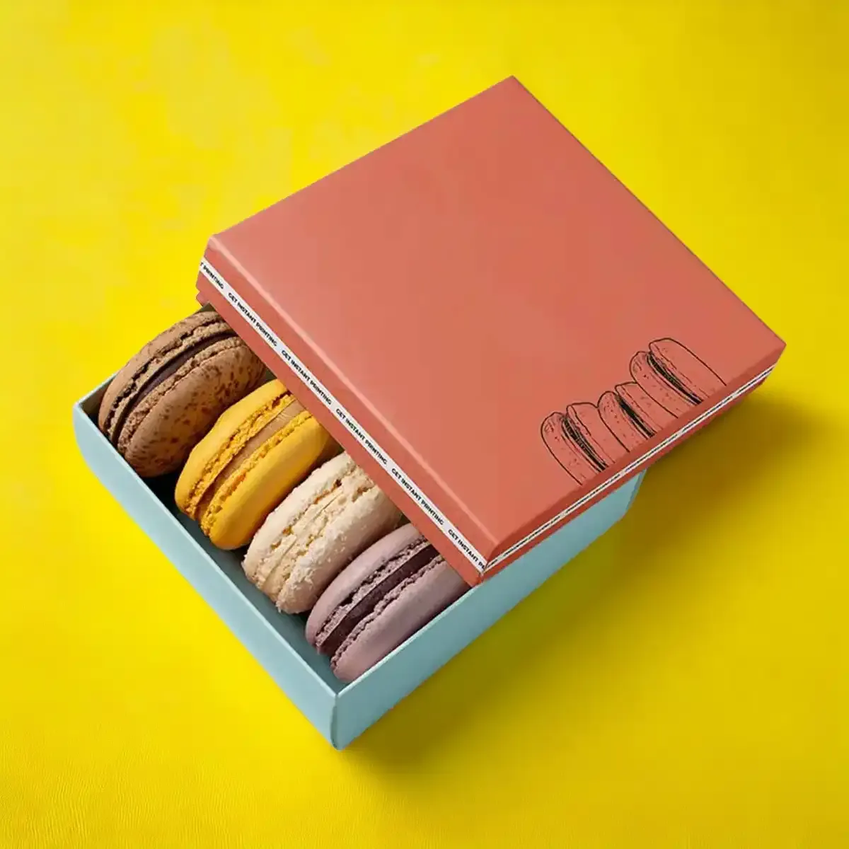 Macaron box open to show a row of macarons