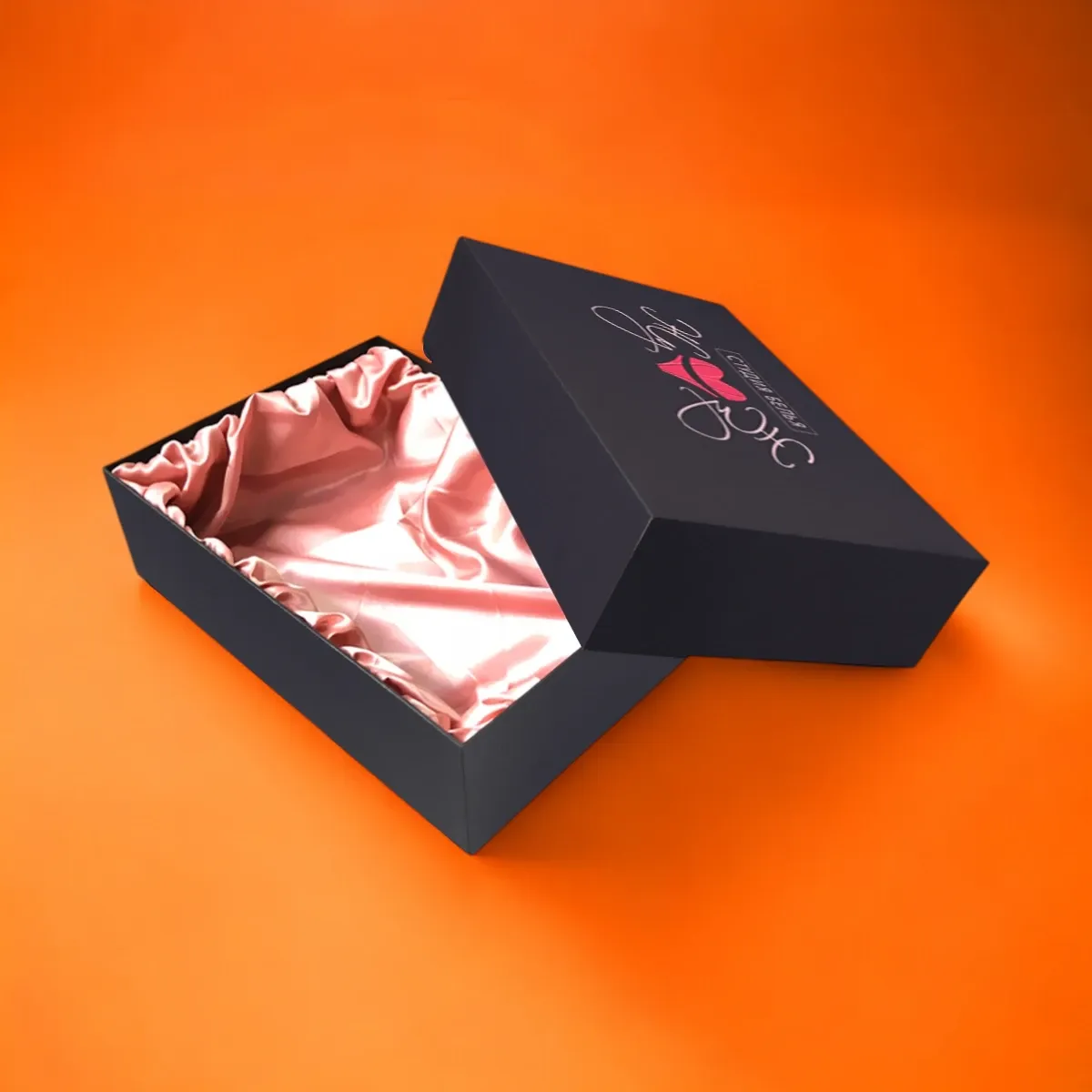 Black rigid apparel box with a pink satin lining